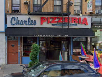 A street view of charles pizzeria, a vintage-style eatery with a sign showcasing its name and establishment year (1964), surrounded by other shops and pedestrian activity.